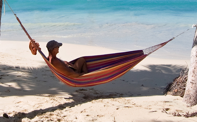 man laying on a Silver One Travel Portable Hammock with Draw String Bag