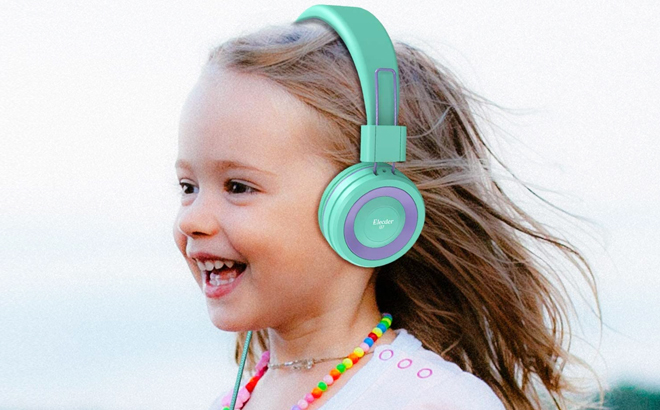A Girl Smiling and Wearing Green Headphones