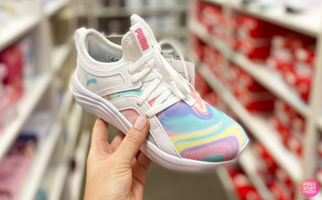 A Hand Holding Puma Softride Swirl Girl Shoes A Hand Holding Puma Softride Swirl Girl Shoes