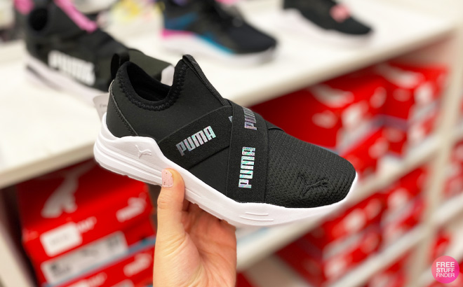 A Hand Holding Puma Wired Slip On Girls Running Shoes