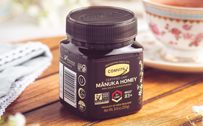 A Jar of Comvita UMF 5 Raw Manuka Honey on a Table