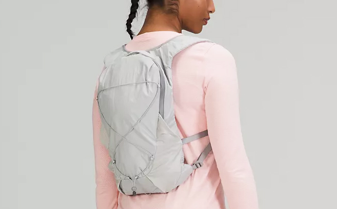 A Woman Carrying Lululemon 10L Active Backpack in Grey Color