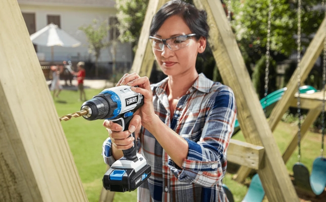 A Woman Using the Hart 20 Volt Cordless 38 inch Drill Driver Kit