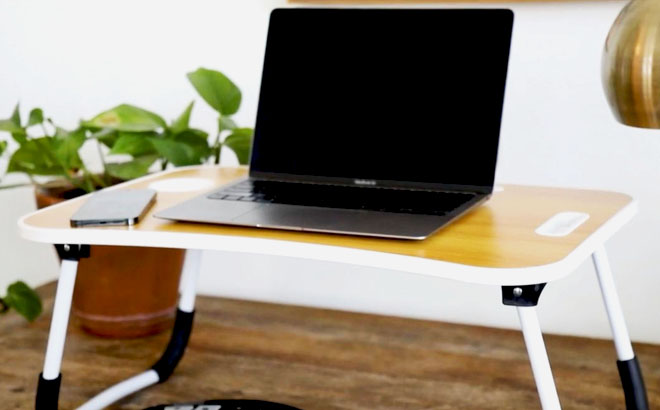 A laptop on a Tech Impressions Multimedia Desk with Cup Holder