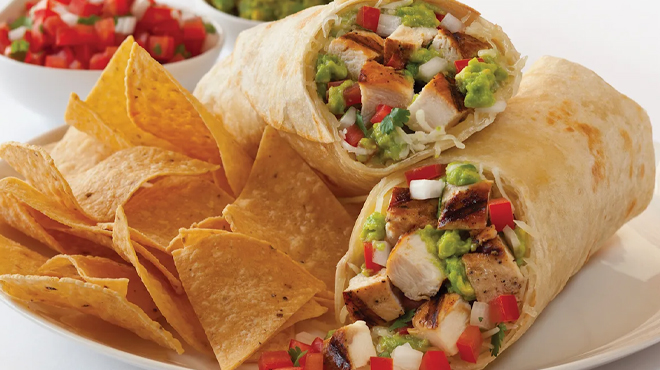 Two Baja Fresh Burritos with Tortilla Chips Next to Them