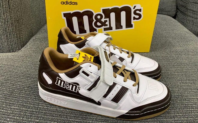 Adidas M&M's Brand Forum Low Shoes in Brown Color on a Sofa with the Shoe Box in the Background Adidas M&M's Brand Forum Low Shoes in Brown Color on a Sofa with the Shoe Box in the Background