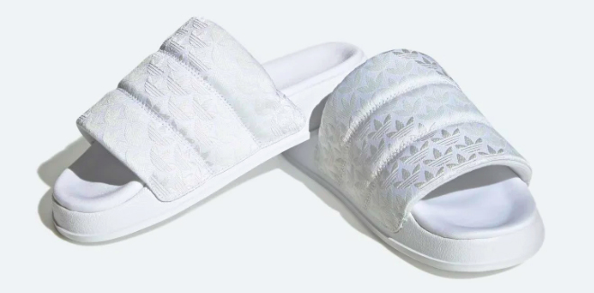 Adidas Womens Adilette Essentials Slides on a Gray Background