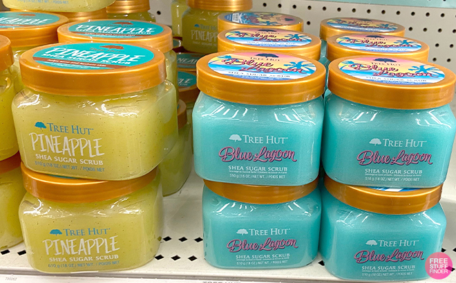 Bunch of Tree Hut Shea Sugar Scrubs in Pineapple and Blue Lagoon Scents on a Store Shelf