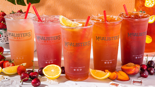Five Glasses of McAlisters Deli Tea on a Table with Fruit