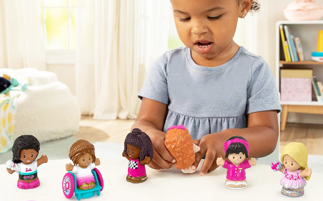 Girl Playing with Fisher Price Little People Barbie