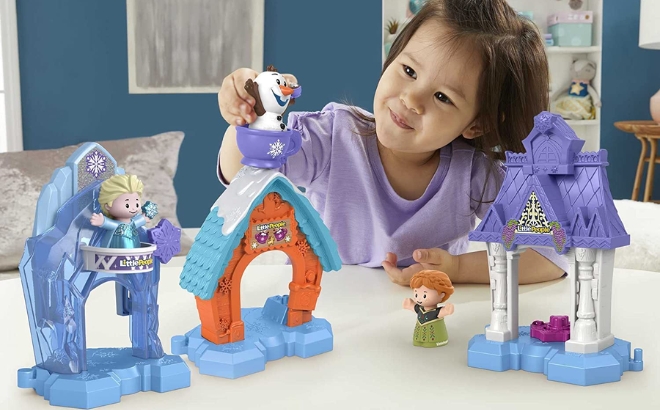 Girl Playing with the Disney Frozen Toddler Toys Little People Snowflake Village Playset