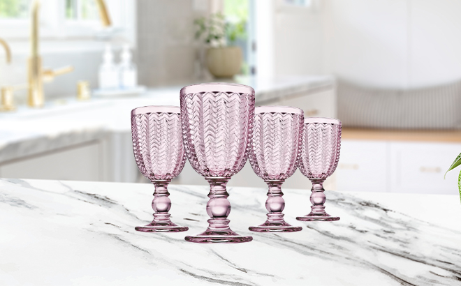 Godinger Carson Wine Vintage Glass Set In Pink Color On A Kitchen Table