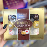 Hand Holding Ferrero Rocher Assorted Hazelnut Milk Chocolate 12 Count Gift Box