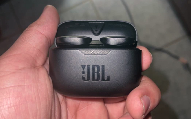 Hand Holding JBL Tune Wireless Noise Cancelling Earbuds