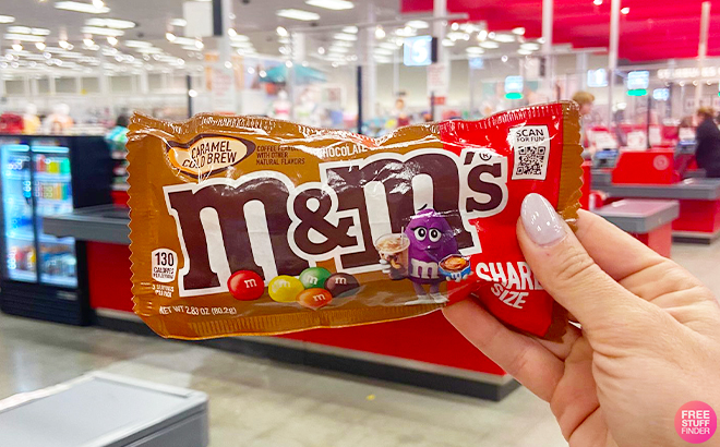 Hand Holding MMs Caramel Cold Brew Candy at Target