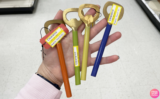 Hand Holding Opalhouse Bottle Openers in Different Colros