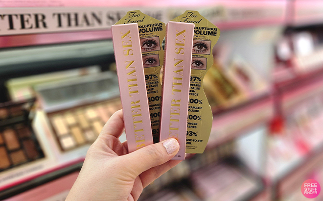 Hand Holding Two Packs of Too Faced Better Than Sex Mascara