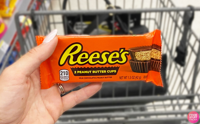 Hand Holding a Pack of Reeses Full Size Peanut Butter Cups