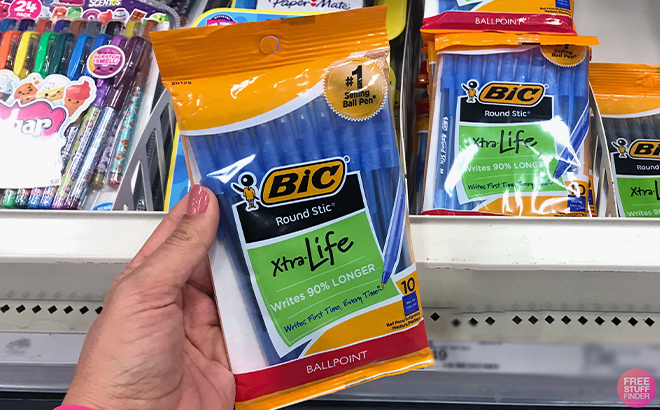 Hand holding BIC Round Stic Xtra Life Blue Ballpoint Pens 10 Count