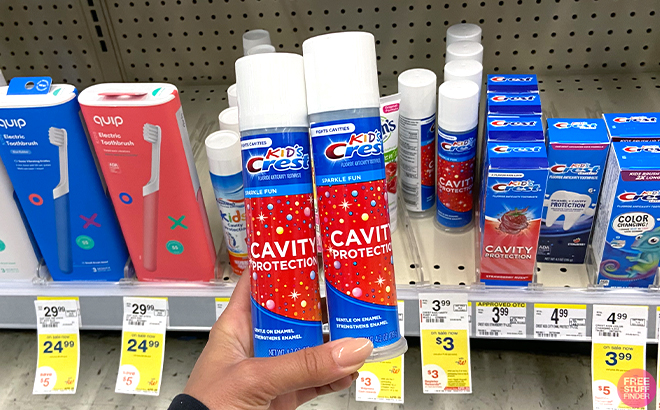 Hand holding two Crest Kids Cavity Protection Toothpastes Hand holding two Crest Kids Cavity Protection Toothpastes