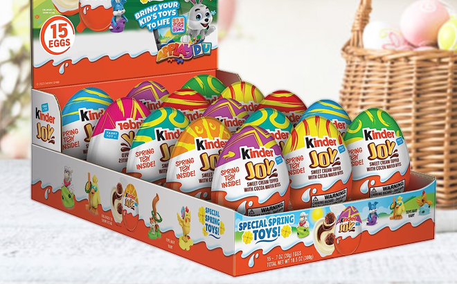 Kinder Joy Easter Eggs 15 Count on a Table with Easter Basket on the Right Side