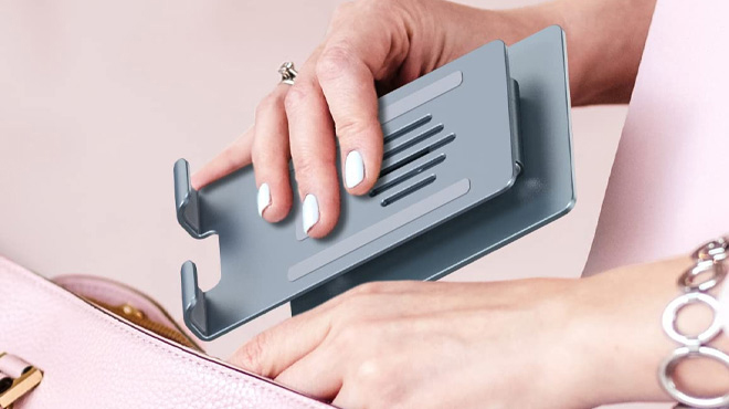 Hand Holding Momax Rotating iPad Stand Momax Rotating iPad Stand with Woman