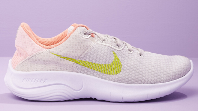 Nike Women's Flex Experience 11 Running Shoe in Bone Color on a Purple Background