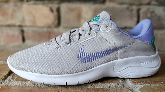 Nike Women's Flex Experience 11 Running Shoe in Silver Color on Brick Floors