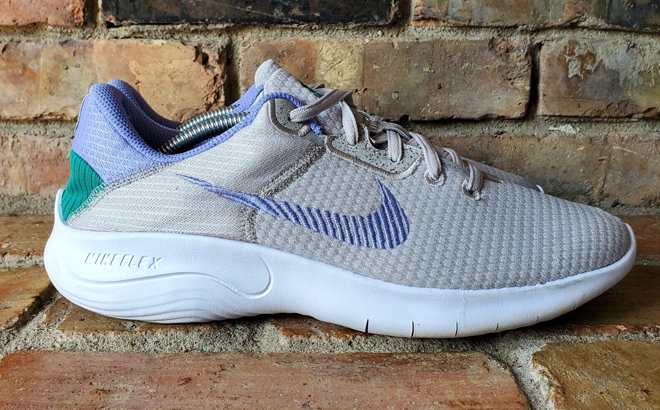 Nike Womens Flex Experience 11 Running Shoes in Grey Color on Brick Floors