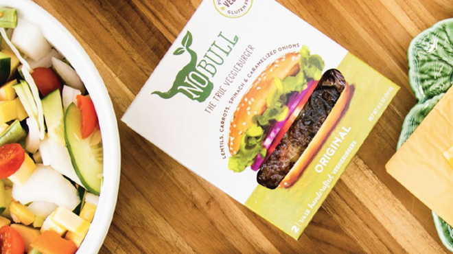 NoBull The True Veggie Burger on a Table beside a Plate of Food