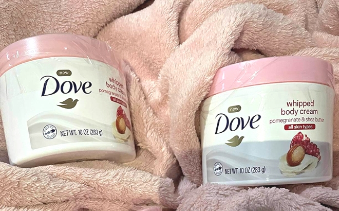 Two Dove Whipped Body Creams on a Pink Blanket