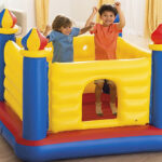 Two Kids Jumping on Intex Jump O Lene Castle Inflatable Bouncer Inside the Living Room