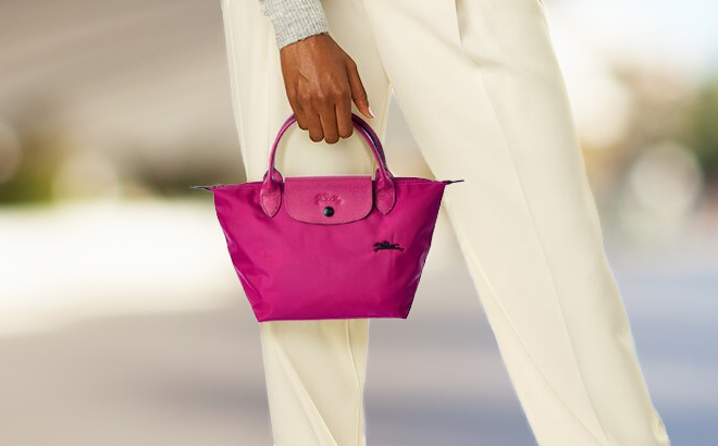 a Person Carrying a Longchamp Pink Color Le Pliage Club Small Nylon Short Handle Tote