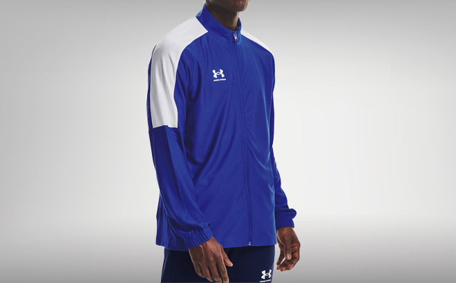 a Person Wearing a Blue Under Armour Mens Challenger Track Jacket with a Gray Background a Person Wearing a Blue Under Armour Mens Challenger Track Jacket with a Gray Background