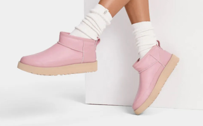 a Person Wearing a Pair of UGG Classic Sugar Ultra Mini Pink Color