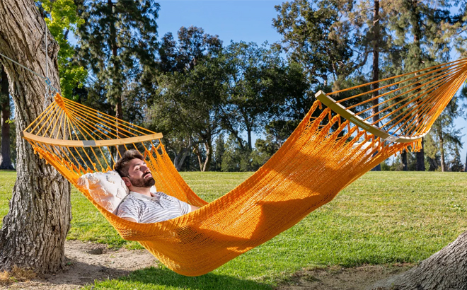 a Person on a Woven Polyester Hammock with Curved Bamboo Spreader Bar