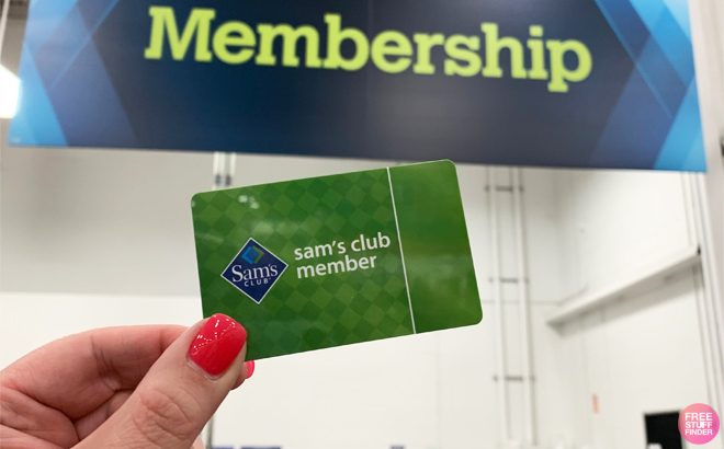 A Hand Holding a Sam's Club Membership Card in a Sam's Club Store