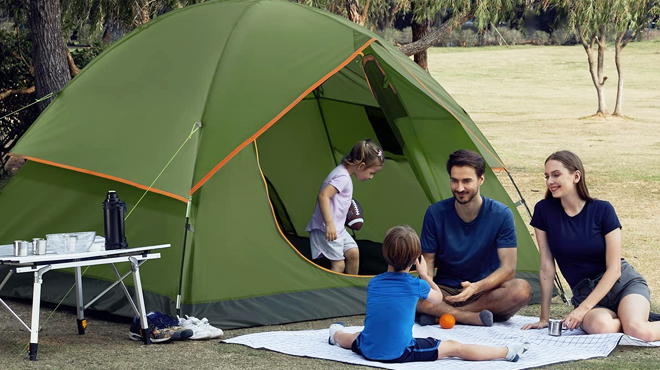 A Family of Four with 6 Person Camping Tent in Green Color in the Park