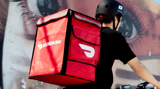 A Guy Driving a Bicyle with DoorDash Bag