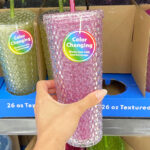 A Hand Holding Mainstays 26 Ounce Color Changing Textured Tumbler Inside Walmart Store
