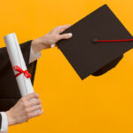 A Person Holding a Graduation Cap and a Diploma