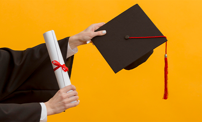 A Person Holding a Graduation Cap and a Diploma