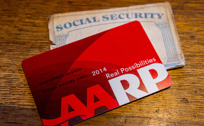 AARP Membership Card on Top of a Social Security Card on a Wooden Surface