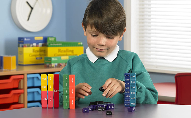 Child Holding Learning Resources Fraction Tower Cube Set