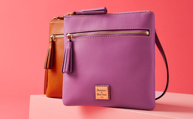 Dooney Bourke Saffiano Double Zip Tassel Crossbody Bags on Pink Product Display