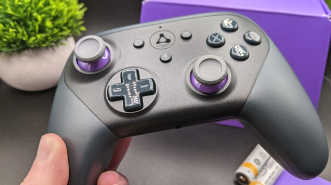 Hand Holding Amazon Official Luna Wireless Controller in Purple and Black