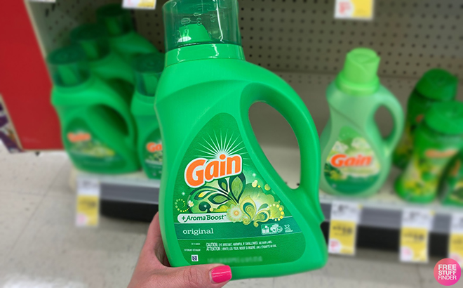 Hand Holding Gain Aroma Boost Liquid Laundry Detergent Original at Walgreens