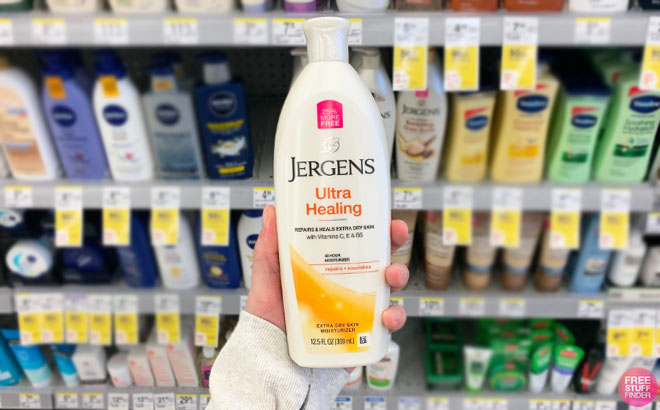 Hand Holding Jergens Ultra Healing Lotion 12 5 Ounce Bottle at Walgreens Store