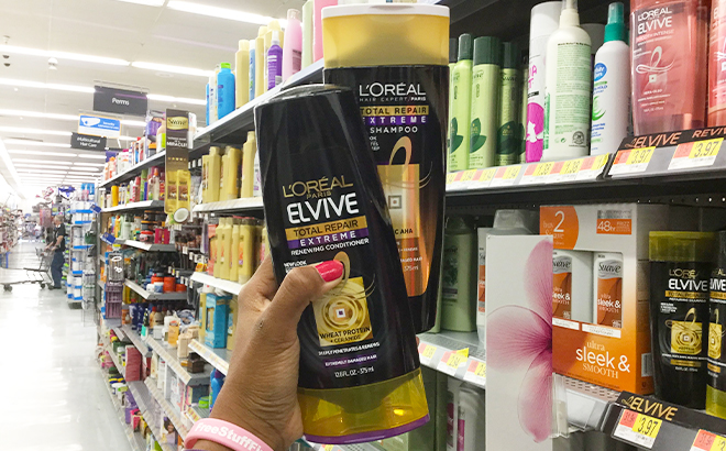 Hand Holding LOreal Elvive Shampoo and Conditioner at Walmart