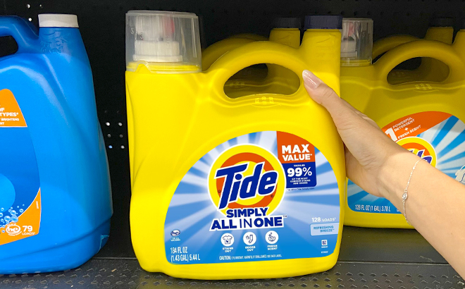 Hand Holding Tide Simply Liquid Laundry Detergent in Refreshing Breeze Scent